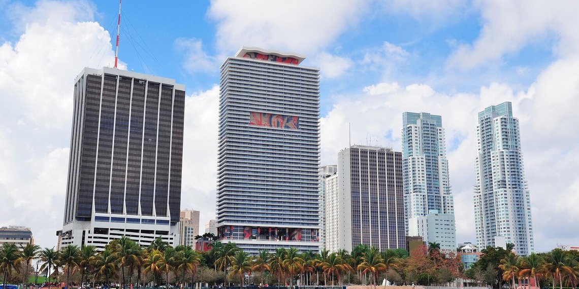 Modern high-rise condominium towers in Singapore against a blue sky