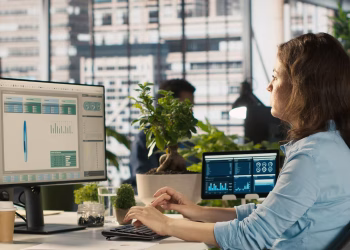 Finance professional using digital dashboards for factoring and accounts receivable management