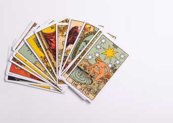 Spread of tarot cards with The Star card on a white background