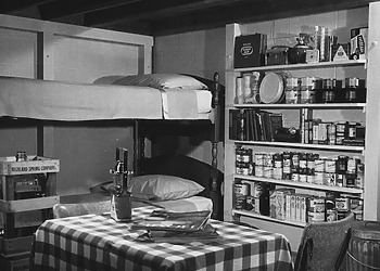 A family fallout shelter stocked with food, water, a battery-operated radio and other emergency supplies, circa 1957.