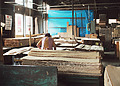 A skilled woodworker carefully grades veneer by eye for its beauty and appearance.