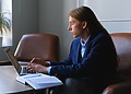 A male technical xxpert sitting at his office desk, typing on his laptop.