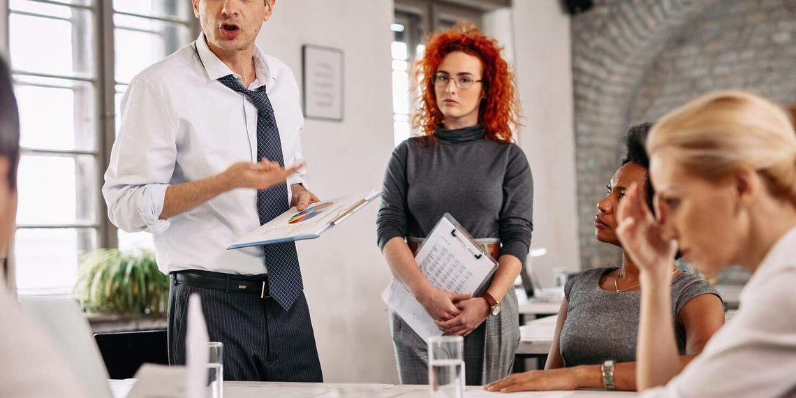 Business leaders reviewing workforce reports during a boardroom meeting
