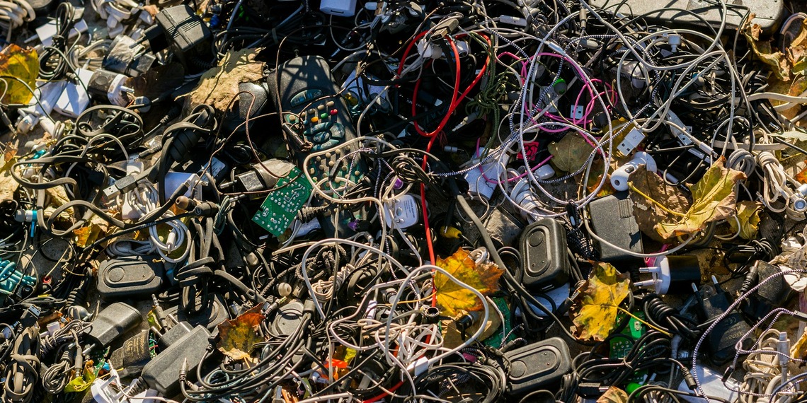 Tangled electronic waste, including cables and chargers.
