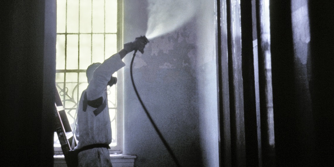 A CDC worker wearing a protective mask and suit.