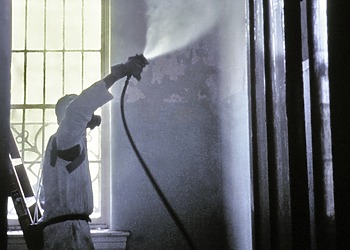 A CDC worker wearing a protective mask and suit.