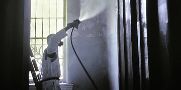 A CDC worker wearing a protective mask and suit.