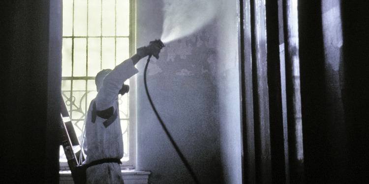 A CDC worker wearing a protective mask and suit.