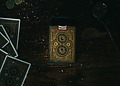 Antique hand painted playing cards laid out on a dark table
