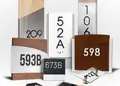 Collection of personalized room signs in wood, acrylic, brushed metal and glass