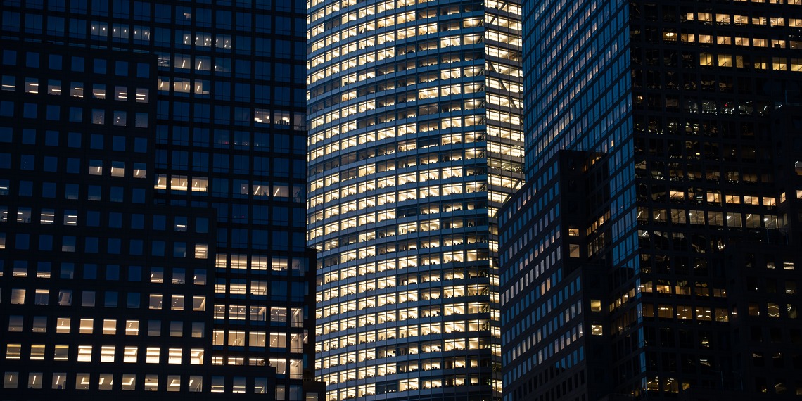 City buildings illuminated at night.