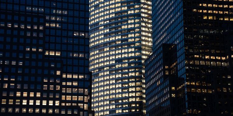 City buildings illuminated at night.