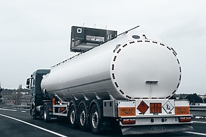 Large truck transporting fuel across a road.