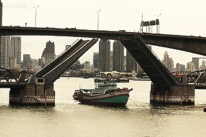 A boat under a low bridge.