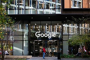 A person stands in front of a Google office building.