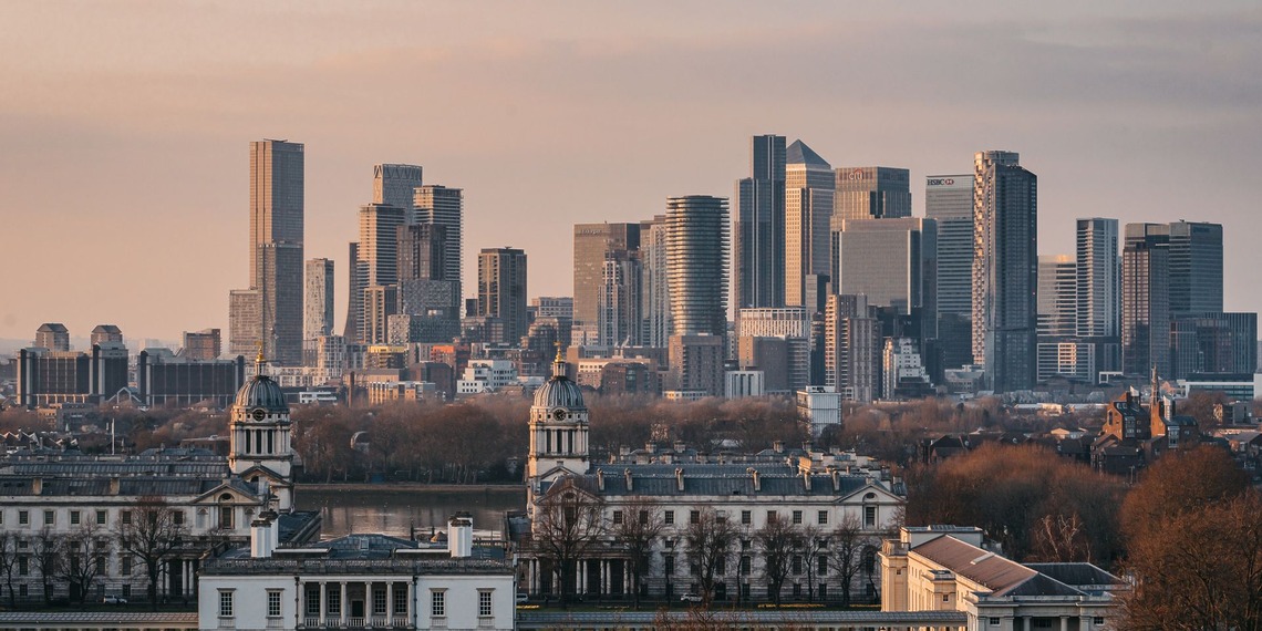 A view of the London skyline from Greenwich Park at sunset.