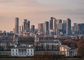 A view of the London skyline from Greenwich Park at sunset.