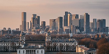 A view of the London skyline from Greenwich Park at sunset.