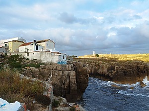 Coastal houses on eroded cliffs overlooking the sea. 