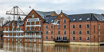 Floodwater rises against brick buildings at Woodsmill Quay in York.