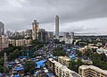 An informal settlement sits beside high-rise towers in Mumbai,