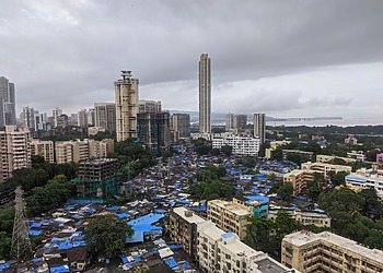 An informal settlement sits beside high-rise towers in Mumbai,
