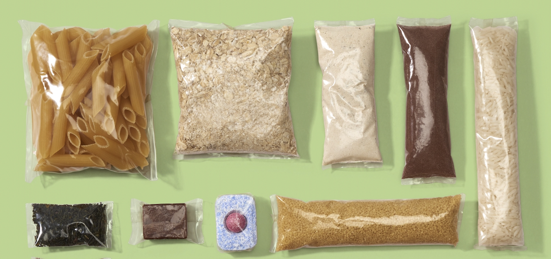 Diverse food products are presented in plant-based plastics.