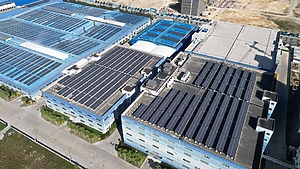 Solar panels cover the roofs of an industrial site.