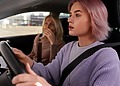 Concerned driver and passenger reacting inside a moving vehicle