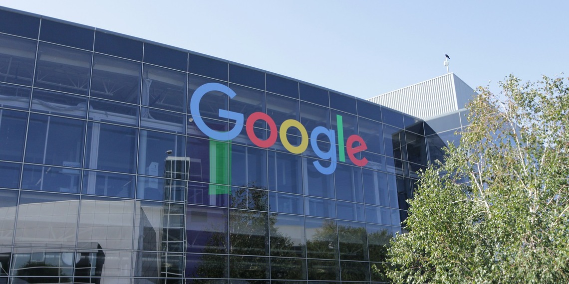 Google logo on the glass facade of an office building.