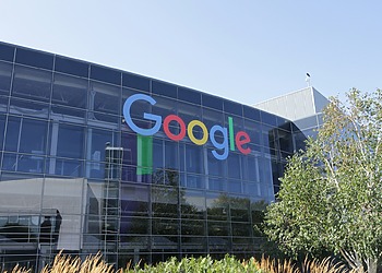 Google logo on the glass facade of an office building.