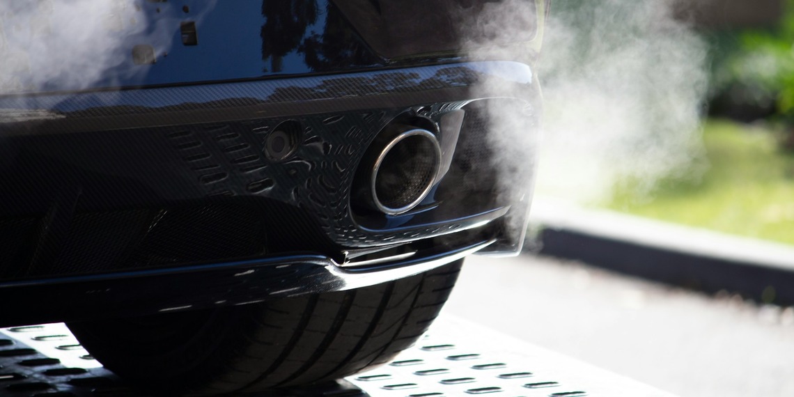 Smoke coming out of a car’s exhaust pipe.