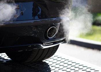 Smoke coming out of a car’s exhaust pipe.