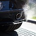 Smoke coming out of a car’s exhaust pipe.