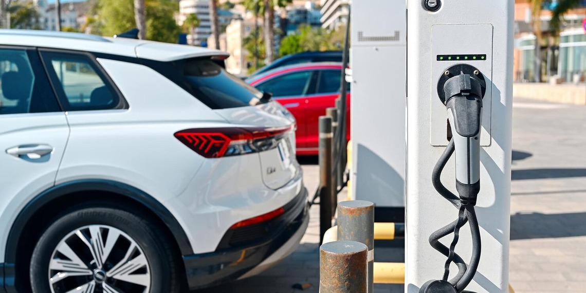Electric vehicles parked beside an EV charging statio
