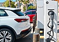 Electric vehicles parked beside an EV charging statio