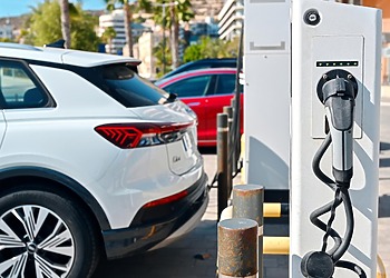 Electric vehicles parked beside an EV charging statio
