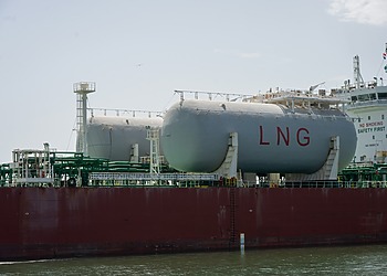 Storage tanks marked LNG on board a vessel.