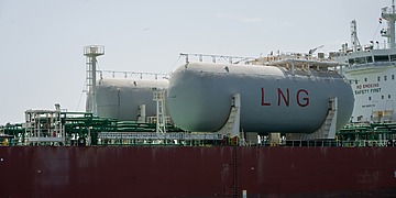 Storage tanks marked LNG on board a vessel.