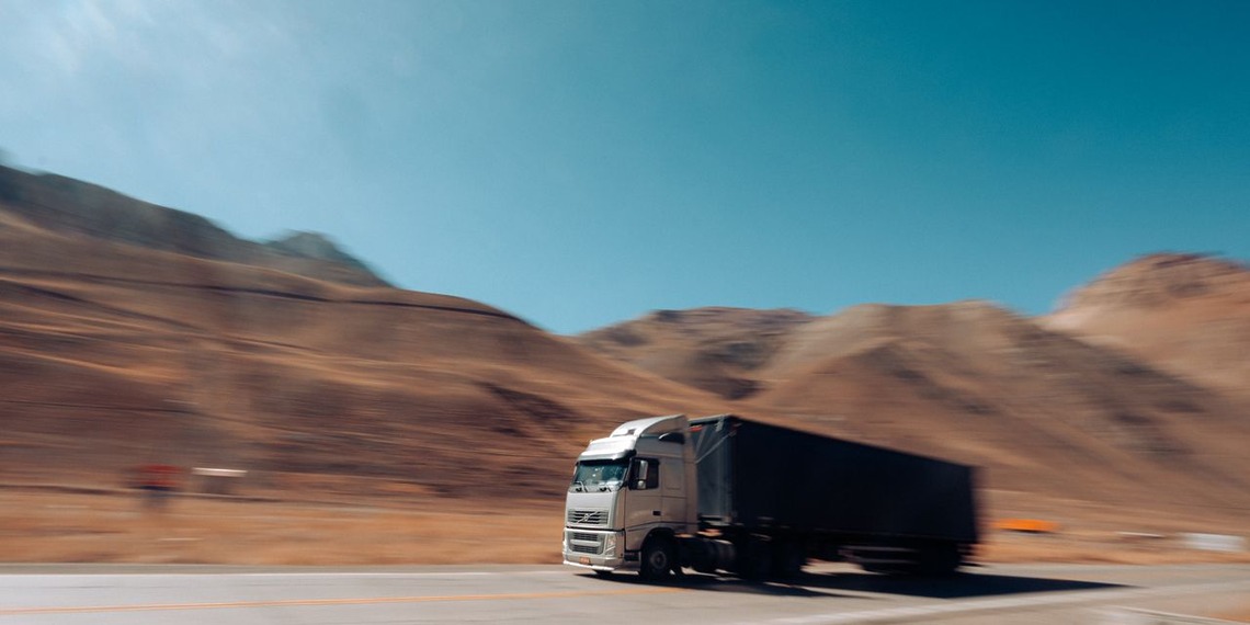 Cargo truck travelling on a mountain road during a long-distance move