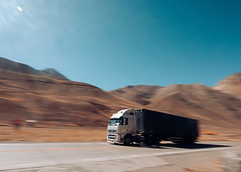 Cargo truck travelling on a mountain road during a long-distance move