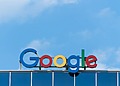 Google logo sign on the roof of an office building.