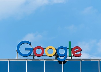 Google logo sign on the roof of an office building.