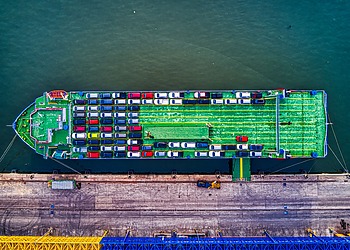 Aerial view of cars loaded on a car carrier ship.