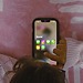 Small child using a smartphone, showing social media apps.