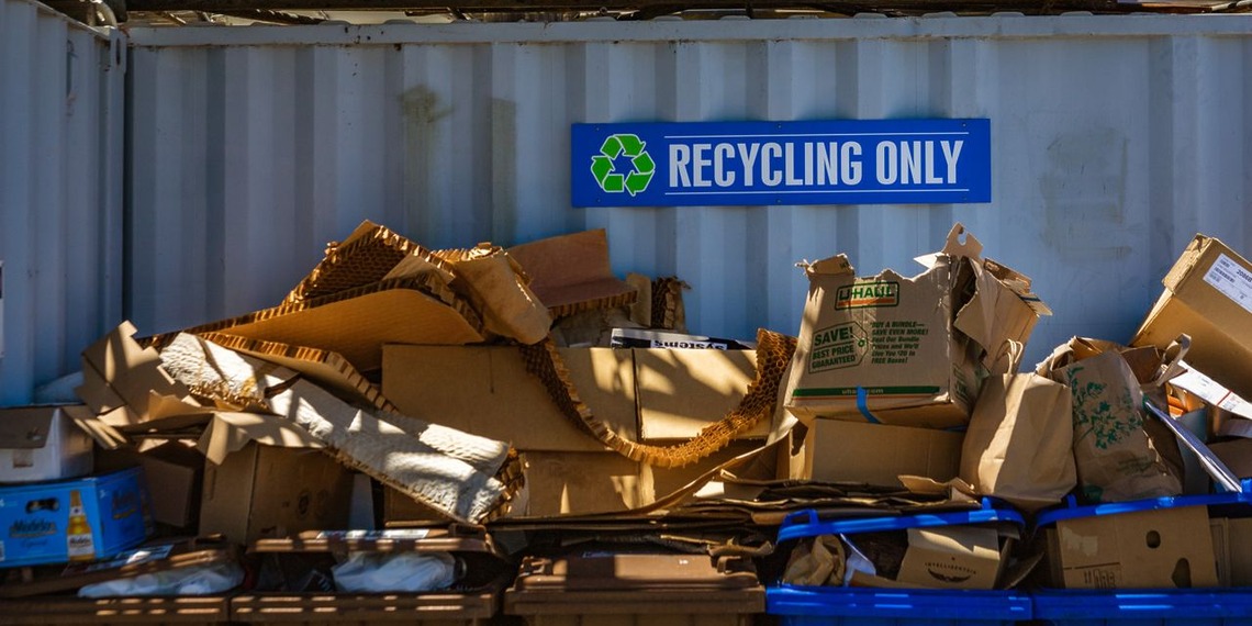 Recycling containers marked for recyclable waste at a waste facility