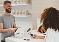 Customer speaking with an employee across a shop counter