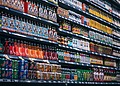 Bottled and canned beverages displayed on supermarket shelves